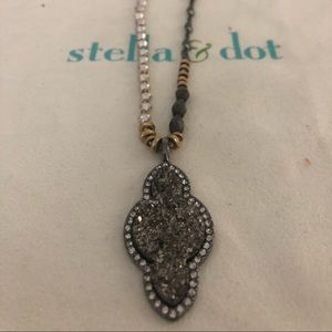 Long neutral beaded necklace.